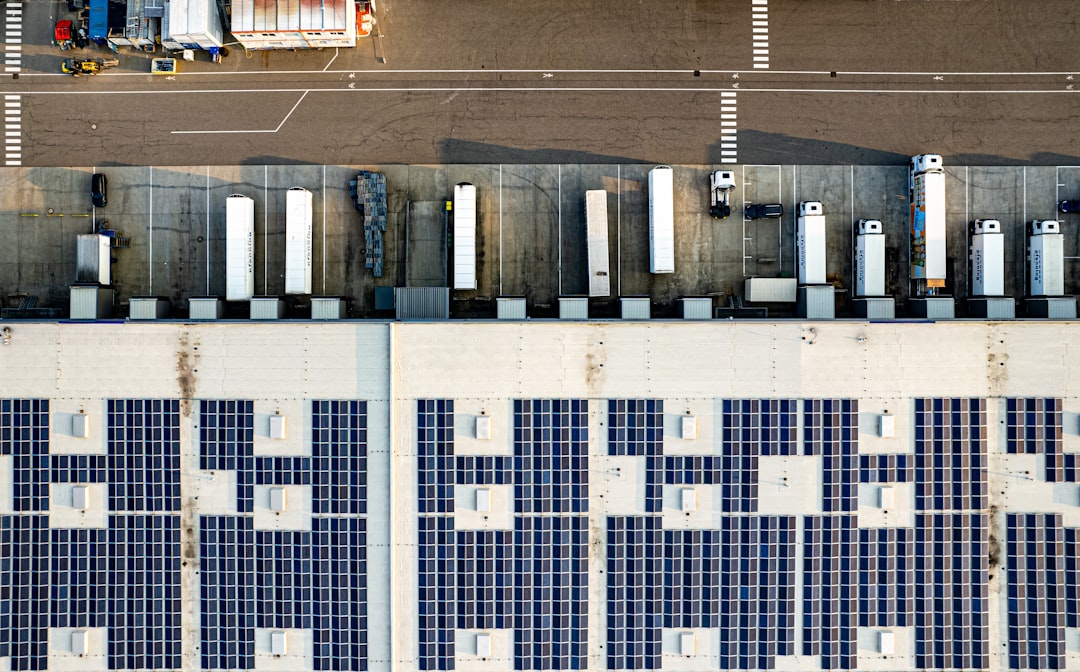 An aerial view of a parking lot with lots of solar panels