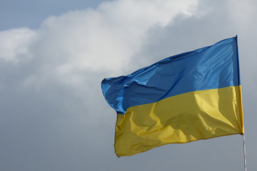 a blue and yellow flag flying in the sky