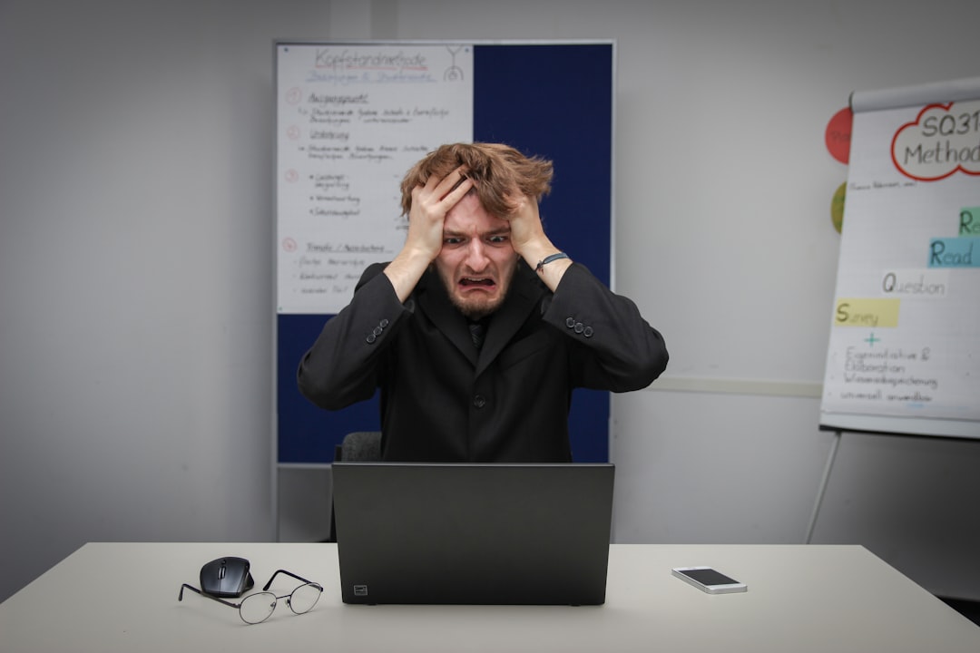 a man holding his face